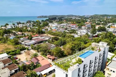 an aerial view of a city with the ocean at 1 BR Balcony Pool and Garden View - Babylon Sky M206 in Rawai Beach