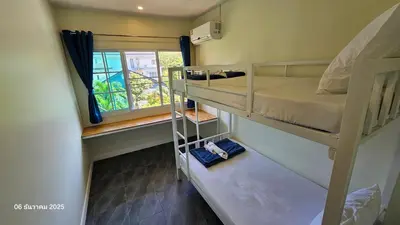 a room with two bunk beds and a window at TwinVillaSky in Ban Muang Mai