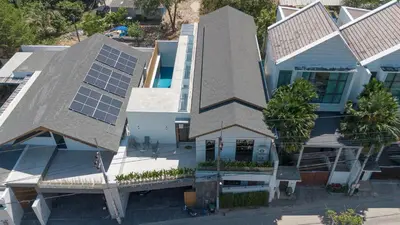 an aerial view of a house with solar panels at PRAIA Residence 4BR - Bangtao in Ban Pak Lak