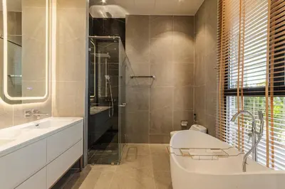 a bathroom with a tub and a sink at PRAIA Residence 4BR - Bangtao in Ban Pak Lak