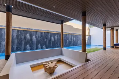 a living room with a bench and a pool at PRAIA Residence 4BR - Bangtao in Ban Pak Lak