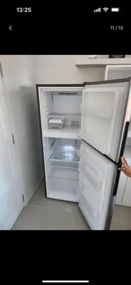 an empty refrigerator with its door open in a kitchen at Charming Condo in Wichit Comfort Meets Convenience in Ban Rangeng