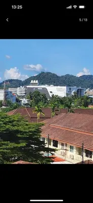 a view of a city with palm trees and a building at Charming Condo in Wichit Comfort Meets Convenience in Ban Rangeng