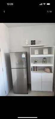 a kitchen with a stainless steel refrigerator and shelves at Charming Condo in Wichit Comfort Meets Convenience in Ban Rangeng