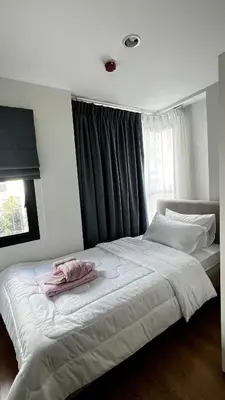 a bedroom with a large white bed with a window at Centrio 2 bed rooms 52 in Ban Lo Long