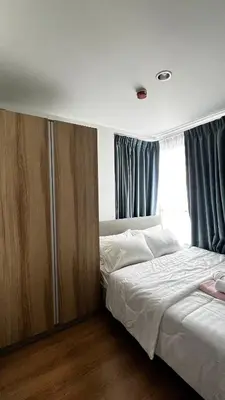 a bedroom with a bed and a large window at Centrio 2 bed rooms 52 in Ban Lo Long