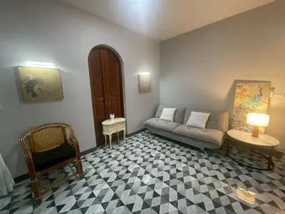 a living room with a couch and a chair at Joyful House in Ban Dan