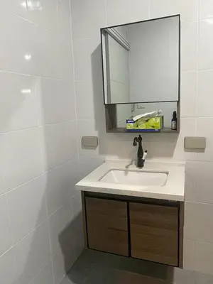 a bathroom with a sink and a mirror at Joyful House in Ban Dan