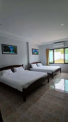 two beds in a room with two windows at Janjira sea view pool villa in Ban Ko Kwang