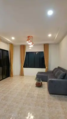 a large living room with a couch and a large window at Janjira sea view pool villa in Ban Ko Kwang