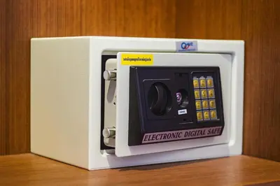 a white microwave oven with an electronic digital safe at SawasdeeCiao Patong Guesthouse in Patong Beach