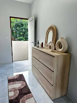 a bathroom with a wooden dresser and a mirror at Kamala Zen house 2BR 15 min walk to beach in Kamala Beach