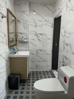 a white bathroom with a toilet and a sink at Kamala Zen house 2BR 15 min walk to beach in Kamala Beach