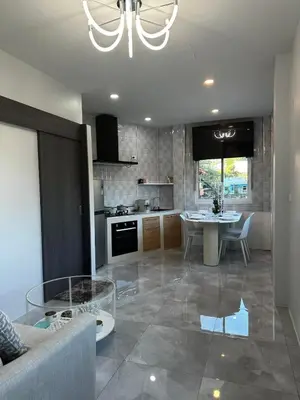 a kitchen and living room with a couch and a table at Kamala Zen house 2BR 15 min walk to beach in Kamala Beach