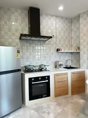 a kitchen with a stove and a refrigerator at Kamala Zen house 2BR 15 min walk to beach in Kamala Beach