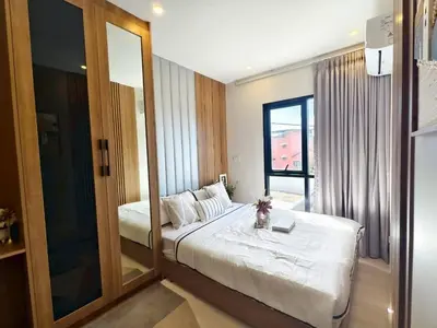 a bedroom with a large mirror and a bed at The Cust Phuket in Ban Khok Chang