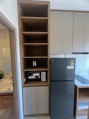 a kitchen with a refrigerator and a microwave at The Cust Phuket in Ban Khok Chang