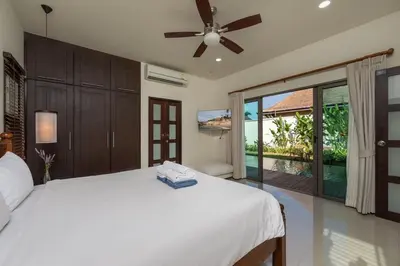 a bedroom with a bed with a ceiling fan at VILLA Kaheru Private Pool Near Nai Harn Beach in Nai Harn Beach