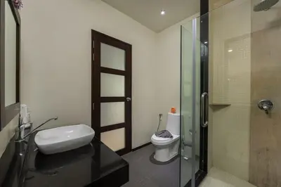a bathroom with a toilet and a glass shower at VILLA Kaheru Private Pool Near Nai Harn Beach in Nai Harn Beach