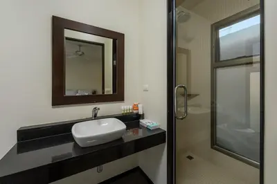 a bathroom with a sink and a mirror and a shower at VILLA Kaheru Private Pool Near Nai Harn Beach in Nai Harn Beach