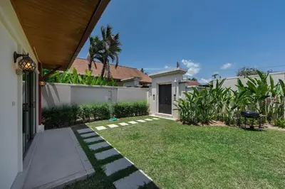 a yard with a fence and a house at VILLA Kaheru Private Pool Near Nai Harn Beach in Nai Harn Beach