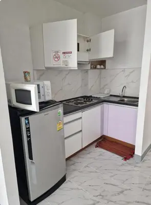 a kitchen with a refrigerator and a microwave at Eid and Philippe's Home building A9 in Ban Ko Kwang