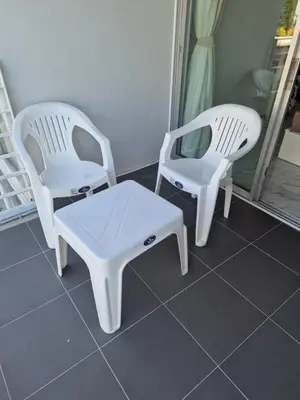 two white chairs and a coffee table on a porch at Eid and Philippe's Home building A9 in Ban Ko Kwang