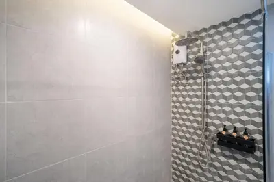 a shower in a bathroom with a tile wall at Heaven pool villa reach beach in 3 mins bangla10m in Patong Beach