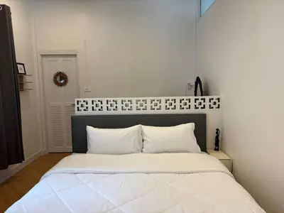a bedroom with a large white bed with white pillows at 3BR Family Villa - 1 km to Chalong Pier with WiFi in Chalong