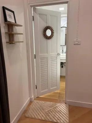 a door leading into a kitchen with a mirror at 3BR Family Villa - 1 km to Chalong Pier with WiFi in Chalong