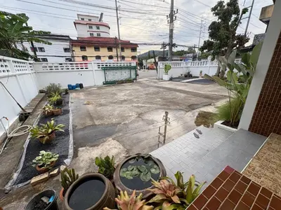 an empty courtyard with potted plants and a building at 3BR Family Villa - 1 km to Chalong Pier with WiFi in Chalong