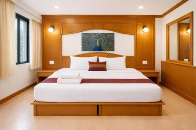 a bedroom with a large bed in a room at Tiger Complex Suites in Patong Beach
