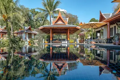 a resort with a pool in front of a house at Arun Rapee Villa Surin Beach in Surin Beach