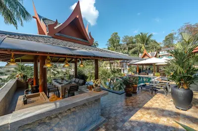 a resort with a swimming pool and a patio at Arun Rapee Villa Surin Beach in Surin Beach