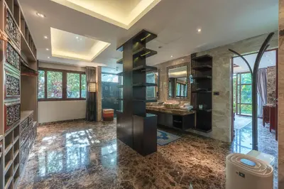 a bathroom with a sink and a large mirror at Arun Rapee Villa Surin Beach in Surin Beach
