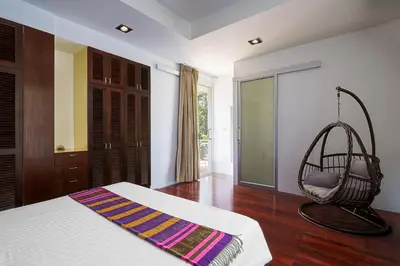 a room with a bed and a swing at Mountain View 4BR Pool Villa Minutes to Kamala in Kamala Beach