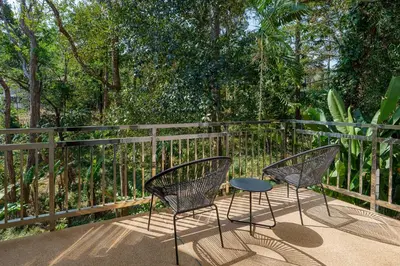 two chairs and a table on a balcony at Mountain View 4BR Pool Villa Minutes to Kamala in Kamala Beach
