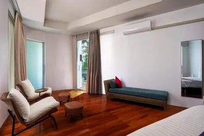 a living room with a couch and a chair in a room at Mountain View 4BR Pool Villa Minutes to Kamala in Kamala Beach