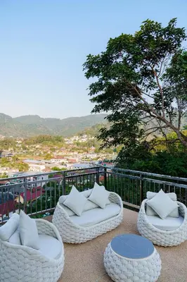 two white chairs and a table on a balcony at Mountain View 4BR Pool Villa Minutes to Kamala in Kamala Beach
