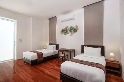 a hotel room with two beds and a table at Mountain View 4BR Pool Villa Minutes to Kamala in Kamala Beach