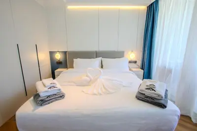 a bedroom with a bed with towels on it at KORA 257 D One-Bedroom Residence in Phuket Town