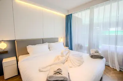 a bedroom with a bed with towels on it at KORA 257 D One-Bedroom Residence in Phuket Town