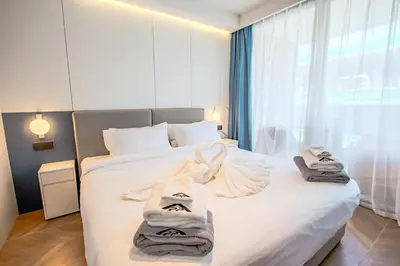 a bedroom with a bed with towels on it at KORA 257 D One-Bedroom Residence in Phuket Town