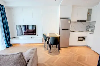 a kitchen with a table and chairs in a room at KORA 257 D One-Bedroom Residence in Phuket Town