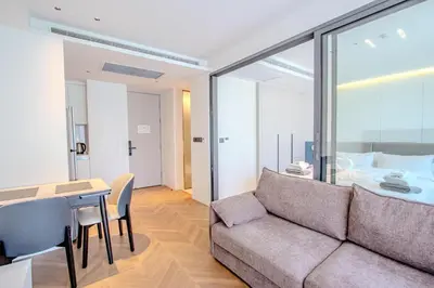 a living room with a couch and a table and a bed at KORA 257 D One-Bedroom Residence in Phuket Town