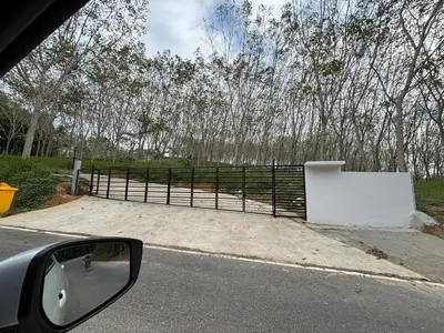 a side view mirror of a car looking at a fence at Natureville cozy home near Samet Nangshe