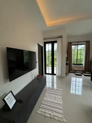 a large living room with a large flat screen tv at Natureville cozy home near Samet Nangshe