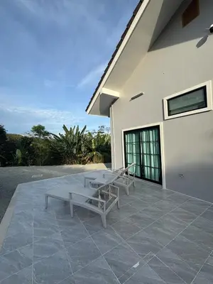 a patio with two benches on the side of a house at Natureville cozy home near Samet Nangshe