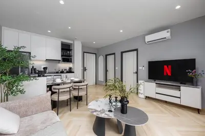 a living room with a tv and a kitchen at Safi 1BR Suite — The Title Legendary BangTao in Bang Tao Beach