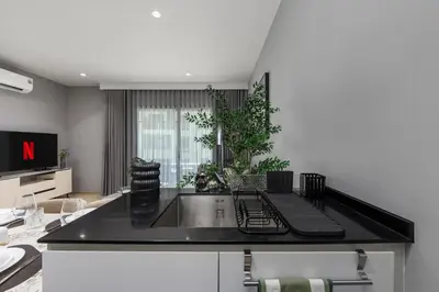 a kitchen with a black counter top and a sink at Safi 1BR Suite — The Title Legendary BangTao in Bang Tao Beach